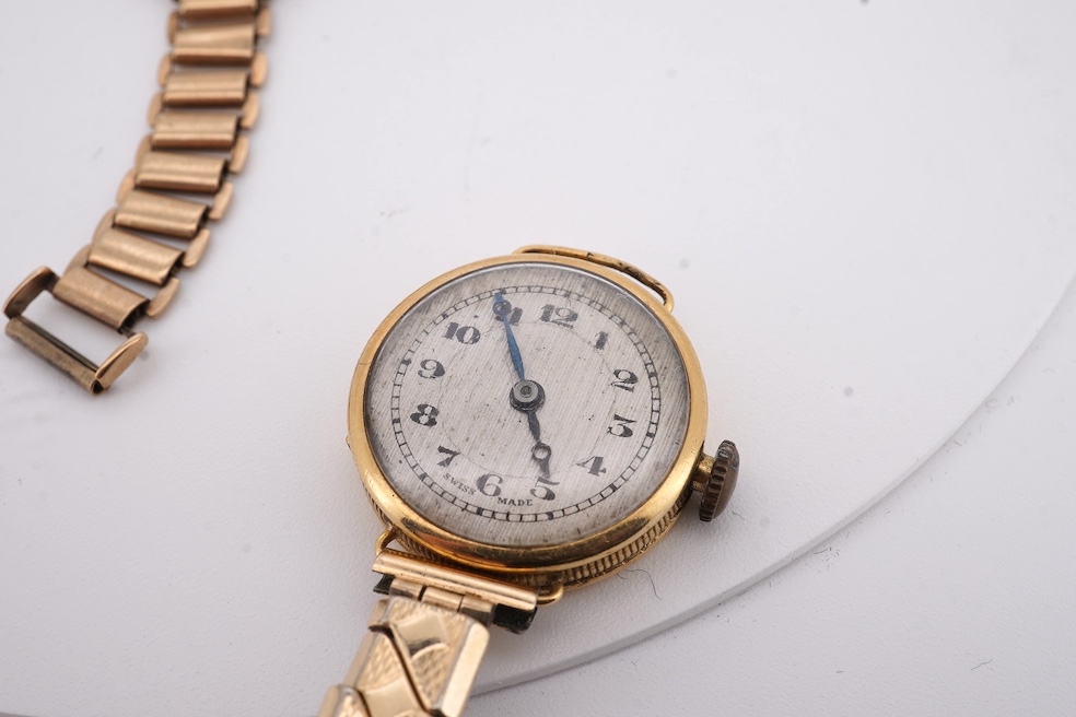 A lady's 1950's 9ct gold Tudor manual wind wrist watch, with Arabic dial, case diameter 18mm, on a damaged 9ct gold bracelet, gross weight 18.6 grams, together with a lady's 18ct gold Buren manual wind wrist watch, on a